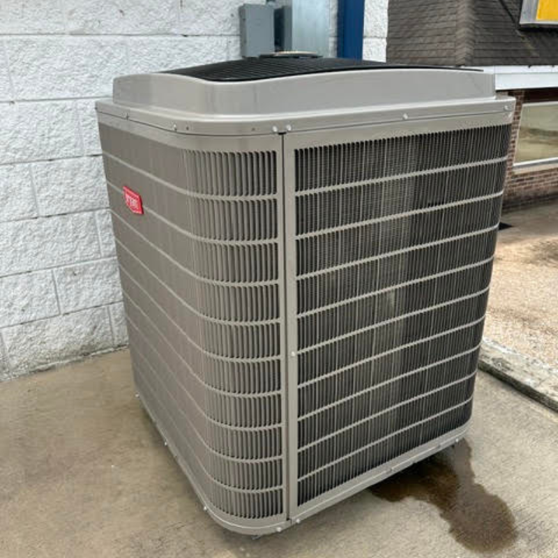 Professional workman in protective clothing adjusting the outdoor unit of the air conditioner or heat pump with digital tablet